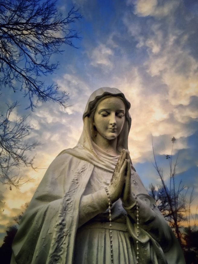 low-angle-view-of-virgin-mary-statue-against-cloudy-sky-597301573-58ab3f063df78c345b031f7f
